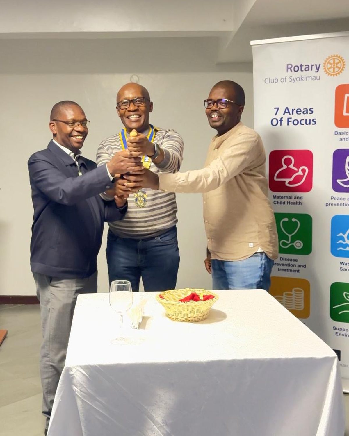 President Taddeo Mwaura, PP Eric Ombok and IPP Barrack Odero raise the club gavel together in a toast to the new Rotary year.
