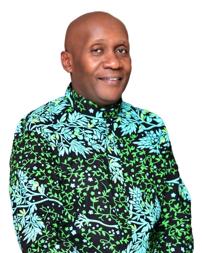 President Taddeo Mwaura, smiling, in a patterned shirt