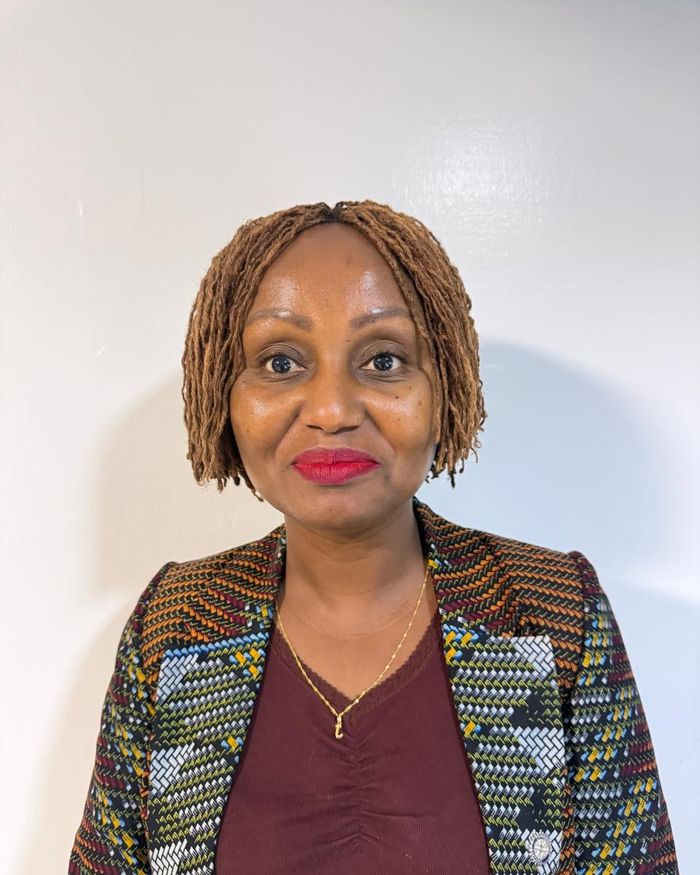 Secretary Janet Muia in a patterned jacket