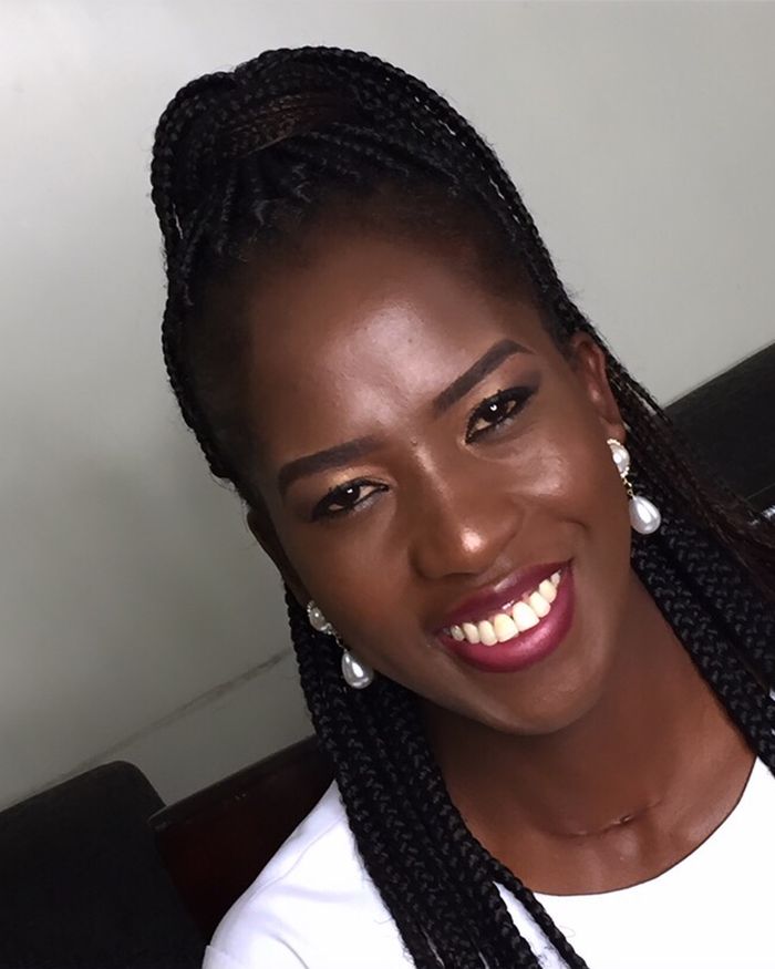Sergeant-at-Arms Elizabeth Nabwana, smiling, in a white top