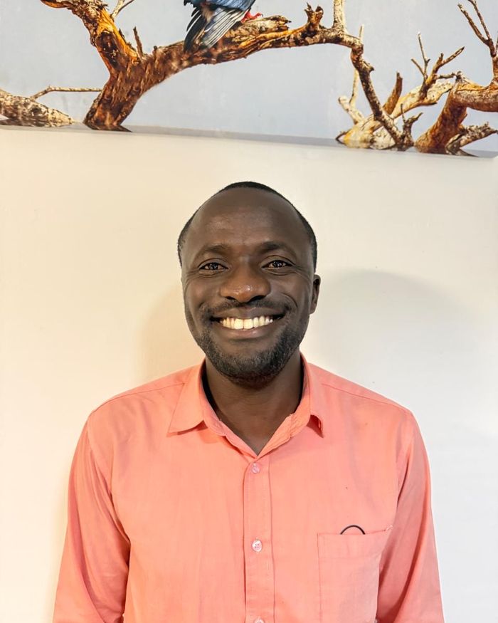 Rotary Foundation Director Lincence Otiende in a coral shirt